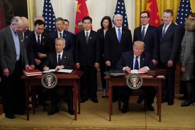 Chinese Vice Premier Liu He and US President Donald Trump sign Chinese Vice Premier Liu He and US President Donald