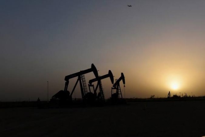 Pump jacks operate at sunset. Oil pump jacks