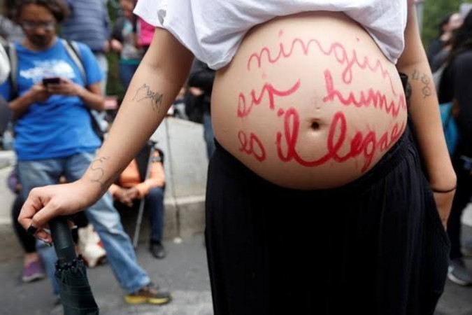 A pregnant woman, seen with the words Pregnant woman