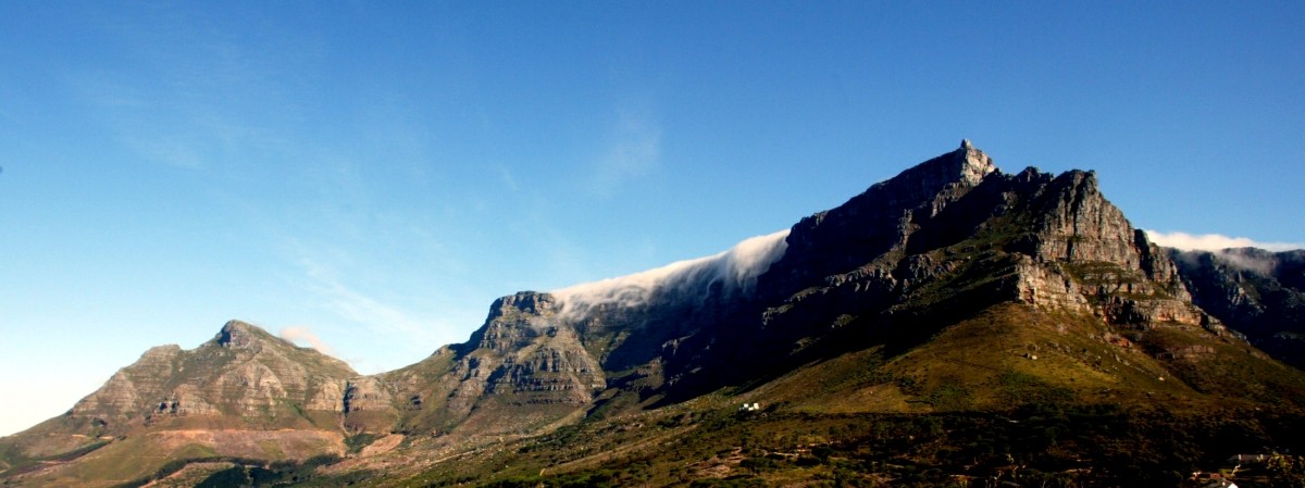 Clouds, driven by seasonal southeasterly winds, billow over Table Mountain in Cape Town. The city's landmark backdrop draws droves of tourists keen to bask in the warm southern hemisphere summer and take in the scenic views. South Africa
