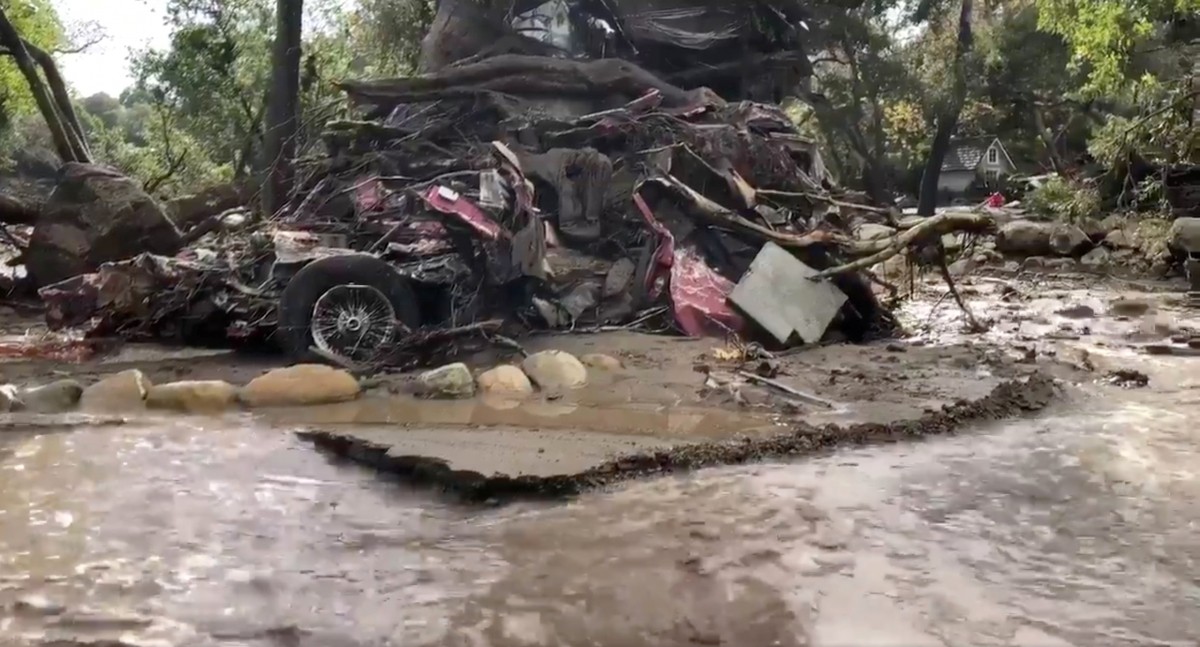 A vehicle is wrapped around a tree after flood and mudslides in Montecito, California California mudslides