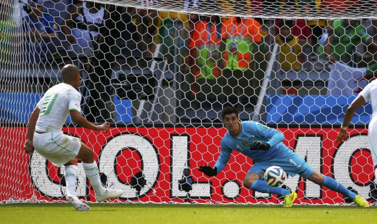 Algeria's Feghouli scores his penalty past Belgium's Courtois during their 2014 World Cup Group H soccer match at the Mineirao stadium in Belo Horizonte Belgium v Algeria