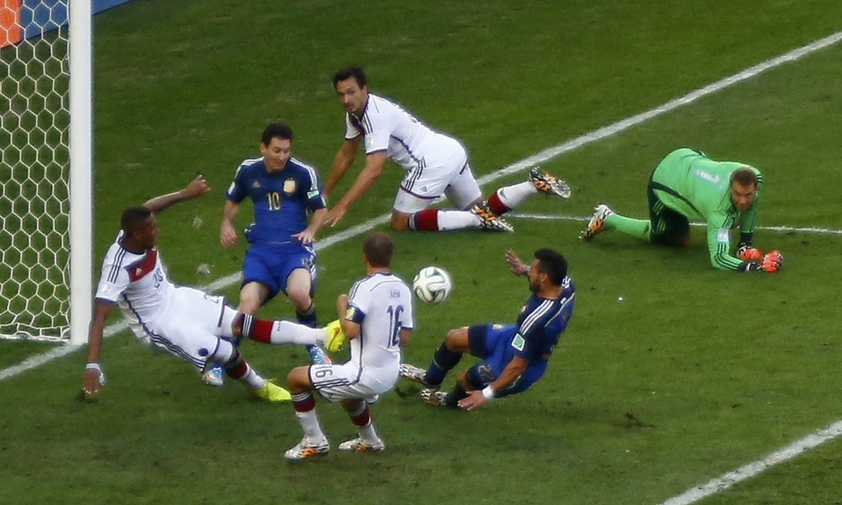 Germany's Boateng kicks the ball past Argentina's Lavezzi and Messi during 2014 World Cup final at the Maracana stadium in Rio de Janeiro. Germany vs Argentina
