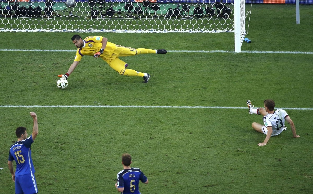 Argentina's goalkeeper Sergio Romero stops a goal attempt by Germany's Thomas Mueller during 2014 World Cup final at the Maracana stadium in Rio de Janeiro. Germany vs Argentina