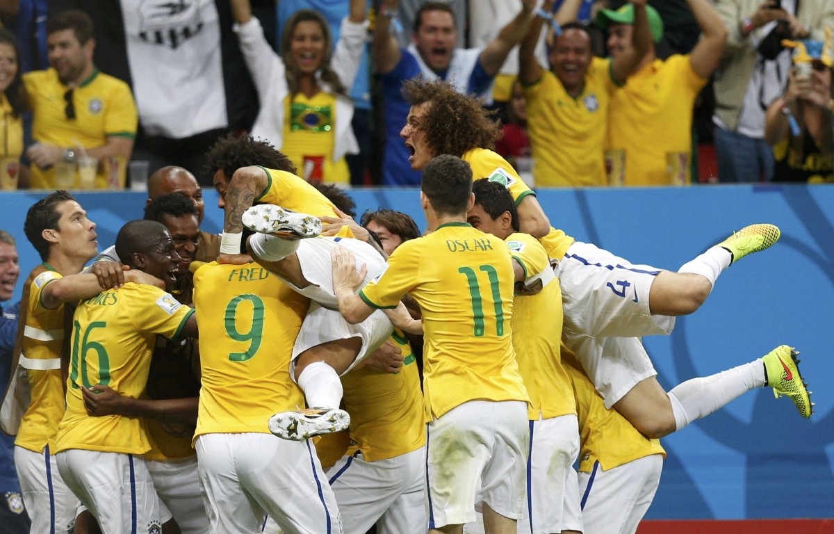 Brazil's Fernandinho celebrates with teammates after scoring a goal during the 2014 World Cup Group A match between Cameroon and Brazil at the Brasilia national stadium Cameroon v Brazil