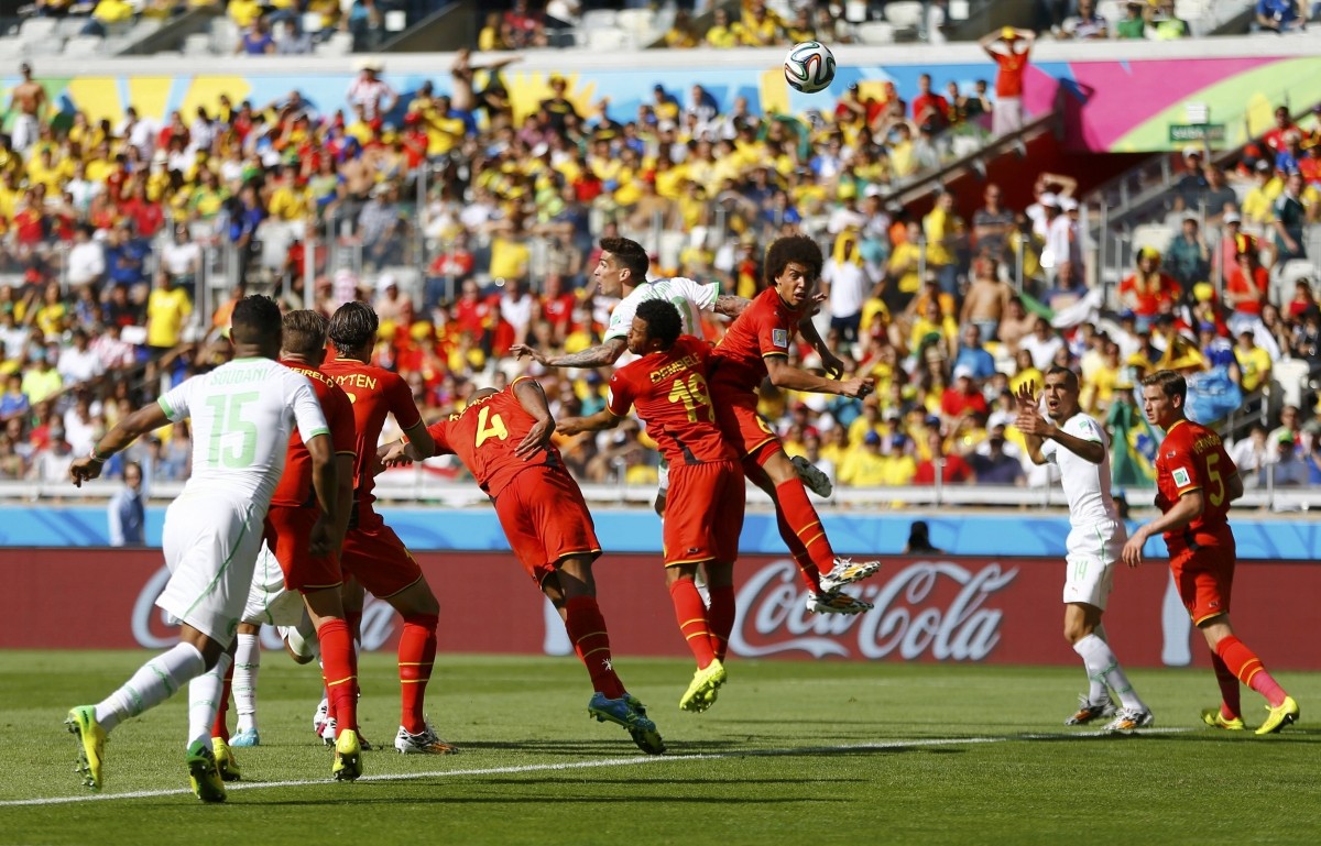 Belgium and Algeria players jump for the ball during their 2014 World Cup Group H soccer match at the Mineirao stadium Belgium v Algeria