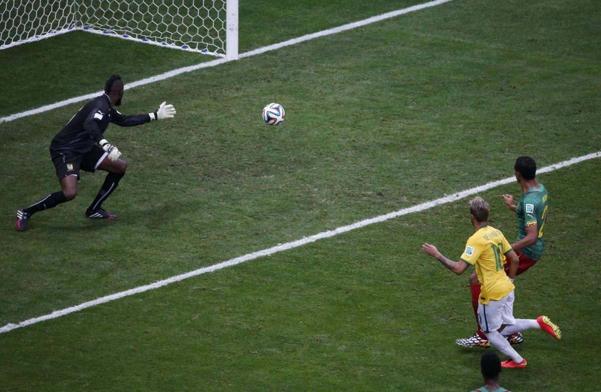 Brazil's Neymar scores against Cameroon during their 2014 World Cup Group A match at the Brasilia national stadium in Brasilia Cameroon v Brazil