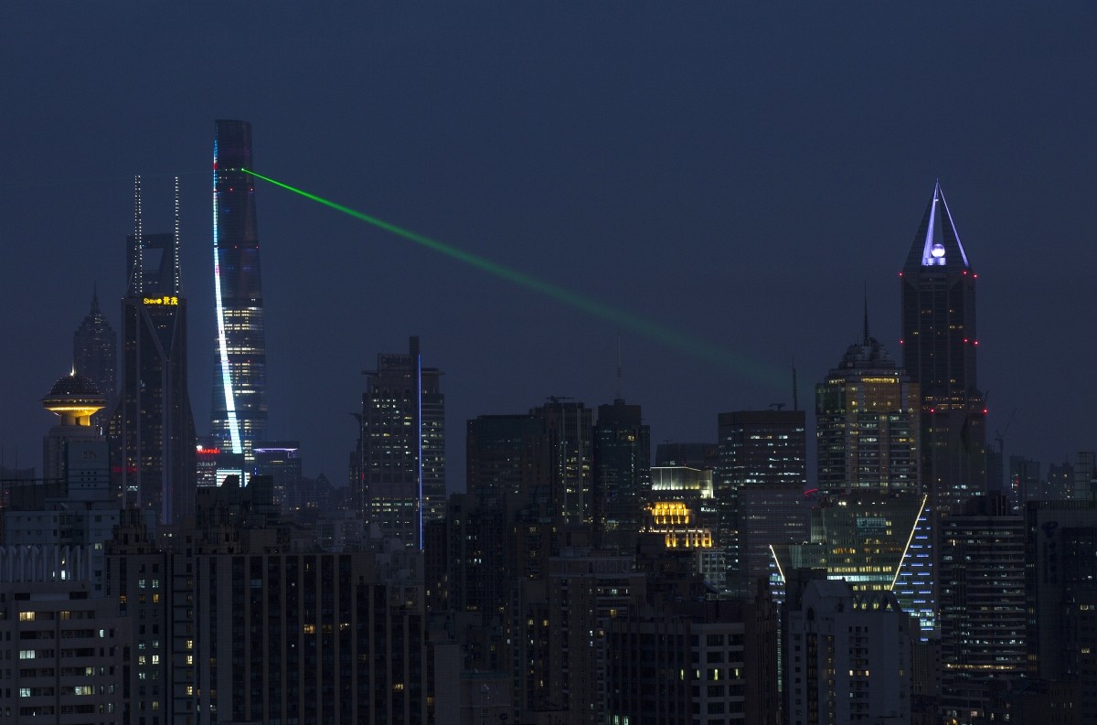 Shanghai Tower (top) is illuminated in the Lujiazui financial district of Pudong in Shanghai December 25, 2014. The building stands at approximately 632 metres (2,073 ft) and will be the tallest skyscraper in China. Shanghai Tower