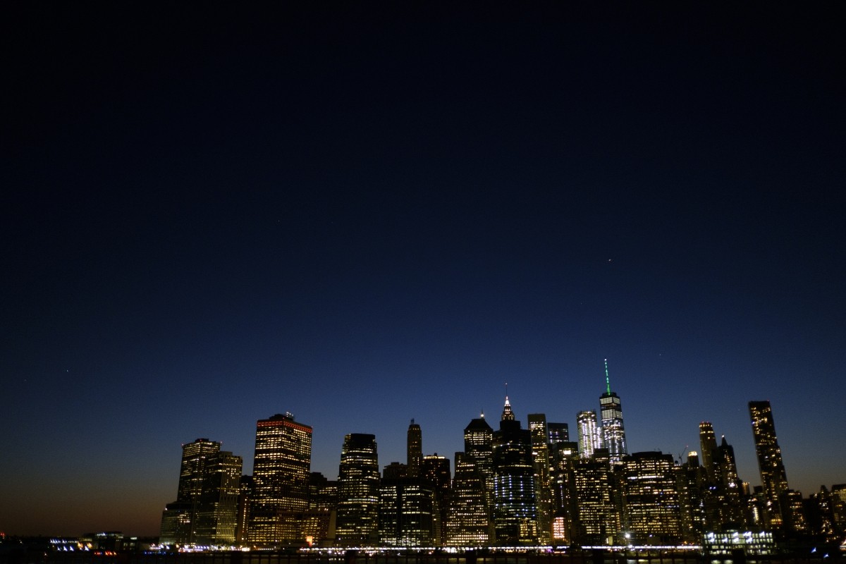 As directed by New York Governor Andrew Cuomo in response to President Donald Trump's decision to pull the United States out of the Paris Climate Accord, One World Trade Center is illuminated with green light, June 1, 2017, in New York City. NYC's One World Trade