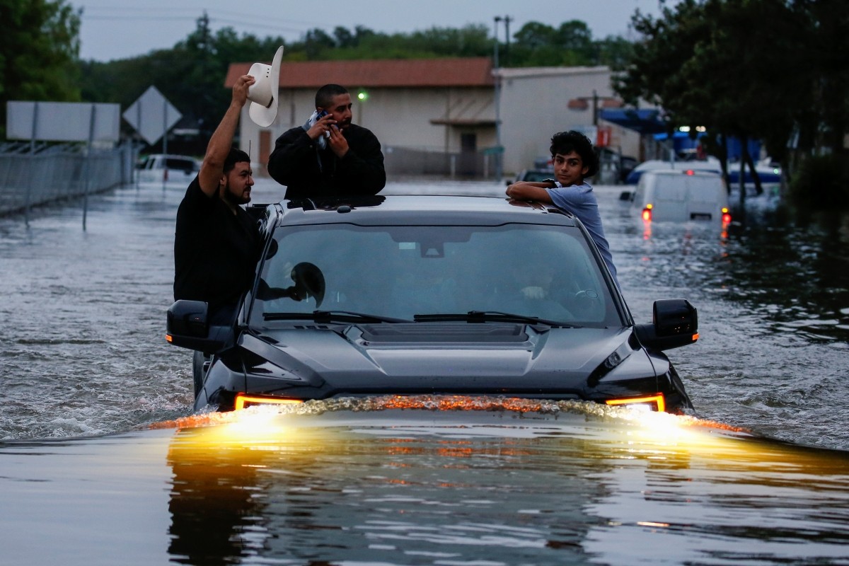 Residents use a truck to navigate through flood waters from Tropical Storm Harvey in Houston, Texas, U.S. Harvey storm