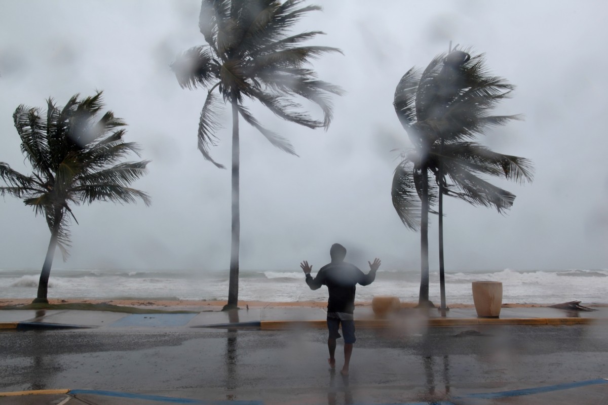 A man reacts in the winds and rain as Hurricane Irma slammed across islands in the northern Caribbean Hurricane Irma