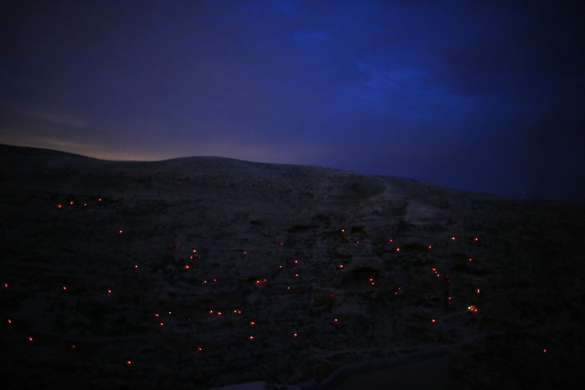 People light candles in small caves near the Mar Saba Monastery in the Judean desert, east of the Palestinian West Bank city of Bethlehem, December 18, 2014. According to the Web site of Israel's tourism ministry, the Greek Orthodox monastery built in the fifth century AD is one of the oldest inhabited monasteries in the world. Israel