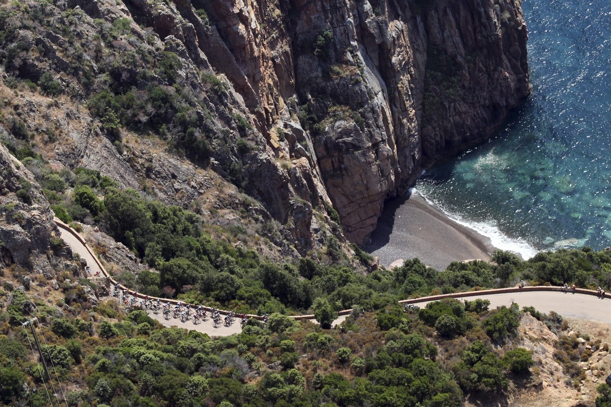 An aerial view shows the pack of riders as they cycle along the coast during the 145.5 km third stage of the centenary Tour de France cycling race from Ajaccio to Calvi, on the French Mediterranean island of Corsica July 1, 2013. Ajaccio