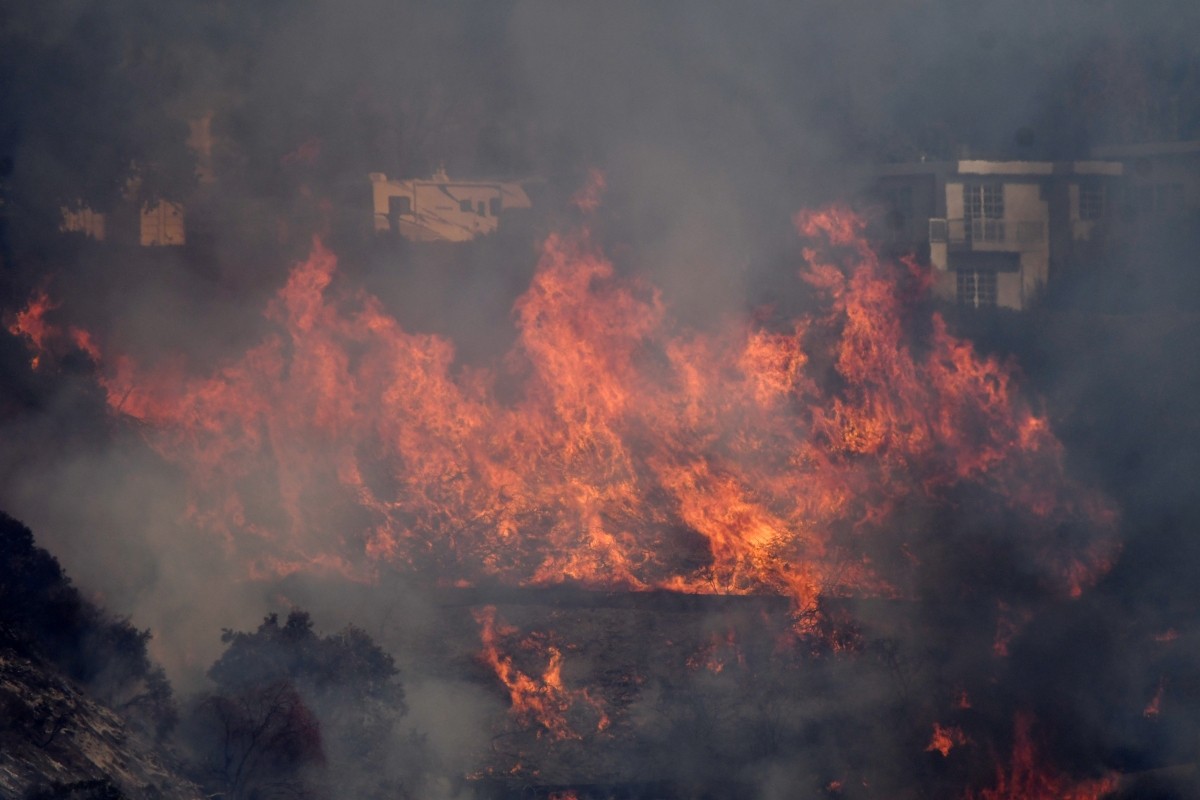 Flames from the Skirball Fire spread on a hillside in a wealthy neighborhood on the west side of Los Angeles Skirball fire