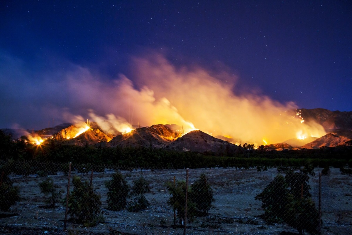 The Thomas Fire burns along a hillside near Santa Paula, California, on December 5, 2017 Thomas Fire