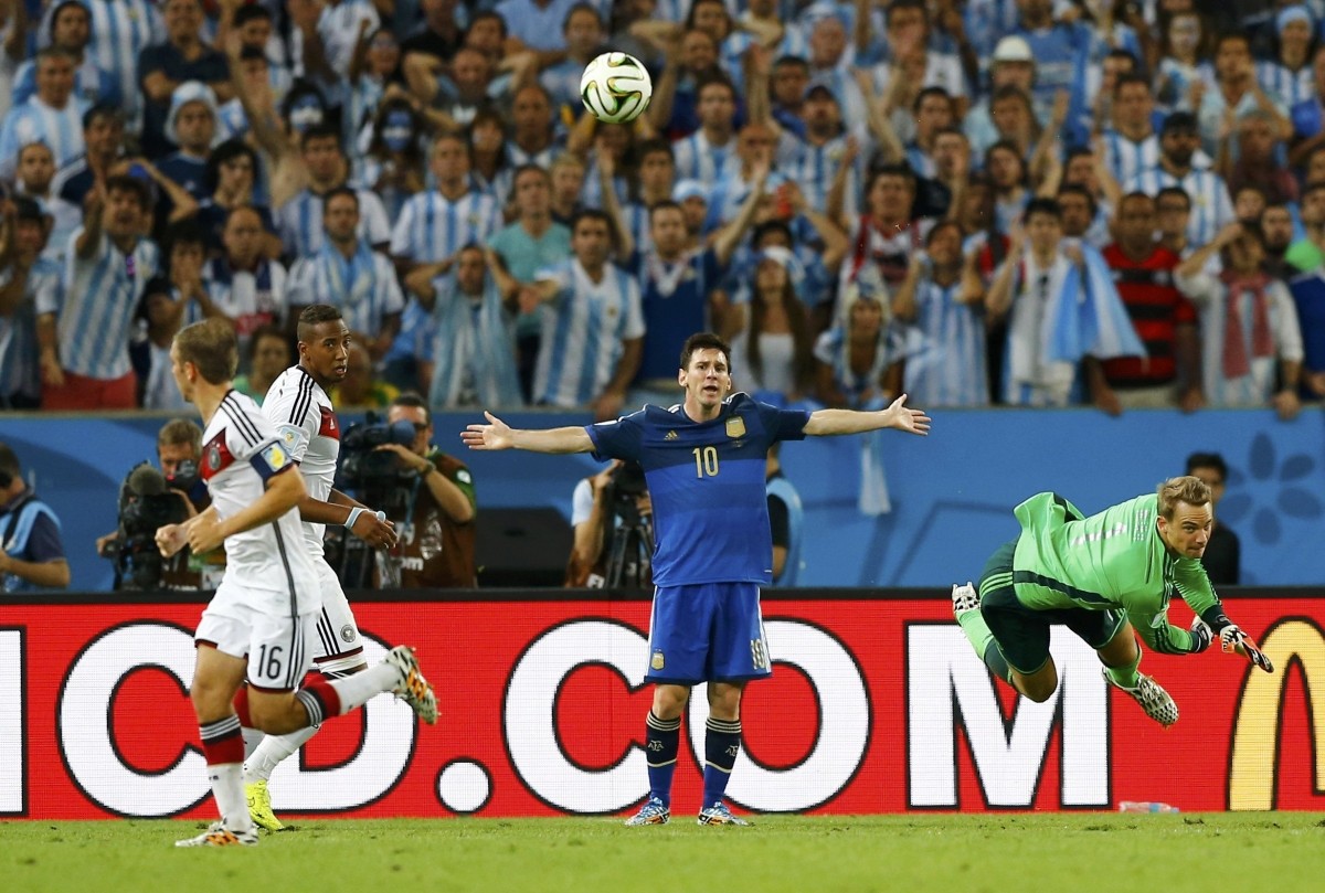 Germany's goalkeeper Manuel Neuer hits the ball out, as Argentina's Lionel Messi reacts during 2014 World Cup final at the Maracana stadium in Rio de Janeiro. Germany vs Argentina