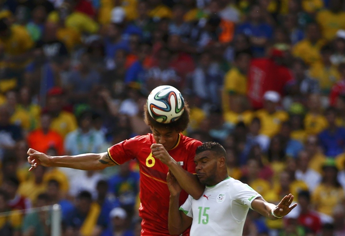 Belgium's Axel Witsel jumps for the ball with Algeria's El Arabi Soudani during their 2014 World Cup Group H soccer match at the Mineirao stadium Belgium v Algeria