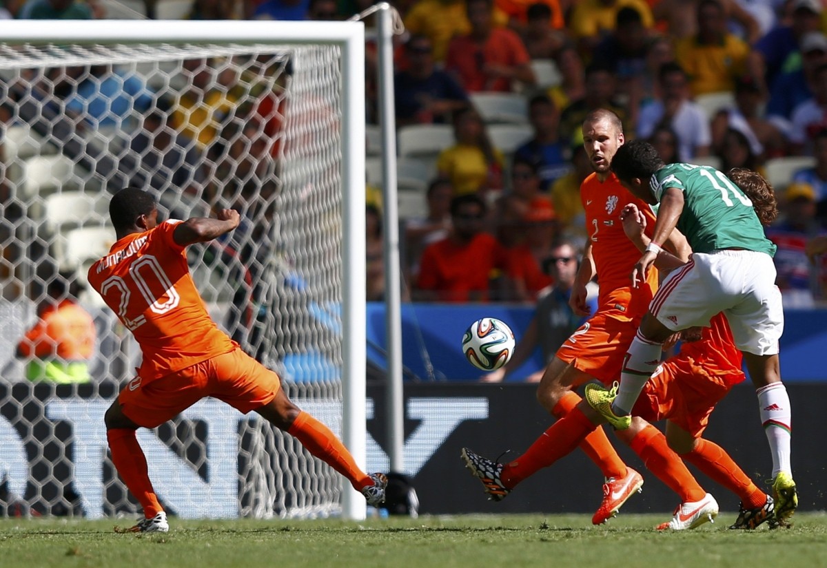 Mexico's Giovani Dos Santos scores a goal during their 2014 World Cup round of 16 game against the Netherlands at the Castelao arena in Fortaleza Netherlands vs Mexico