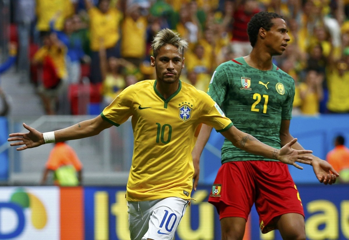 Brazil's Neymar celebrates after scoring a goal during the 2014 World Cup Group A match between Cameroon and Brazil at the Brasilia national stadium Cameroon v Brazil