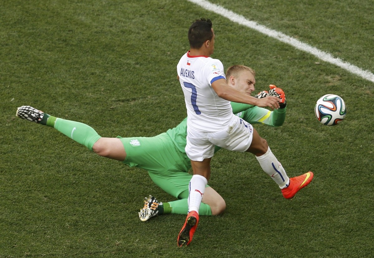 Goalkeeper Cillessen of the Netherlands saves the ball in front of Chile's Sanchez during their 2014 World Cup Group B match in Sao Paulo Netherlands v Chile