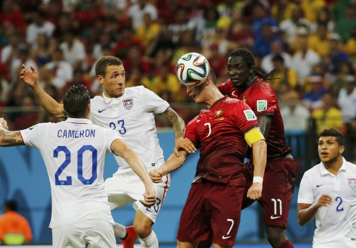 Portugal's Ronaldo jumps to head the ball near teammate Eder, Cameron and Johnson of the U.S. during their 2014 World Cup G match at the Amazonia arena in Manaus USA vs Portugal