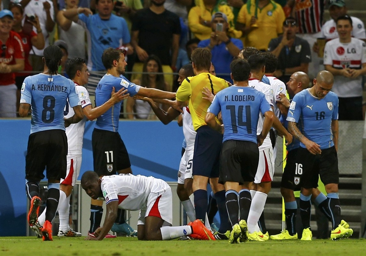Uruguay's Maximiliano Pereira walks off the pitch after receiving a red card Uruguay v Costa Rica