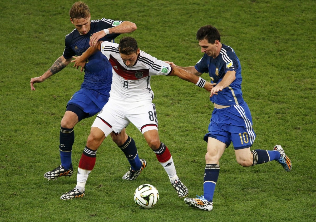 Germany's Ozil is challenged by Argentina's Messi and Biglia during 2014 World Cup final at the Maracana stadium in Rio de Janeiro. Germany vs Argentina
