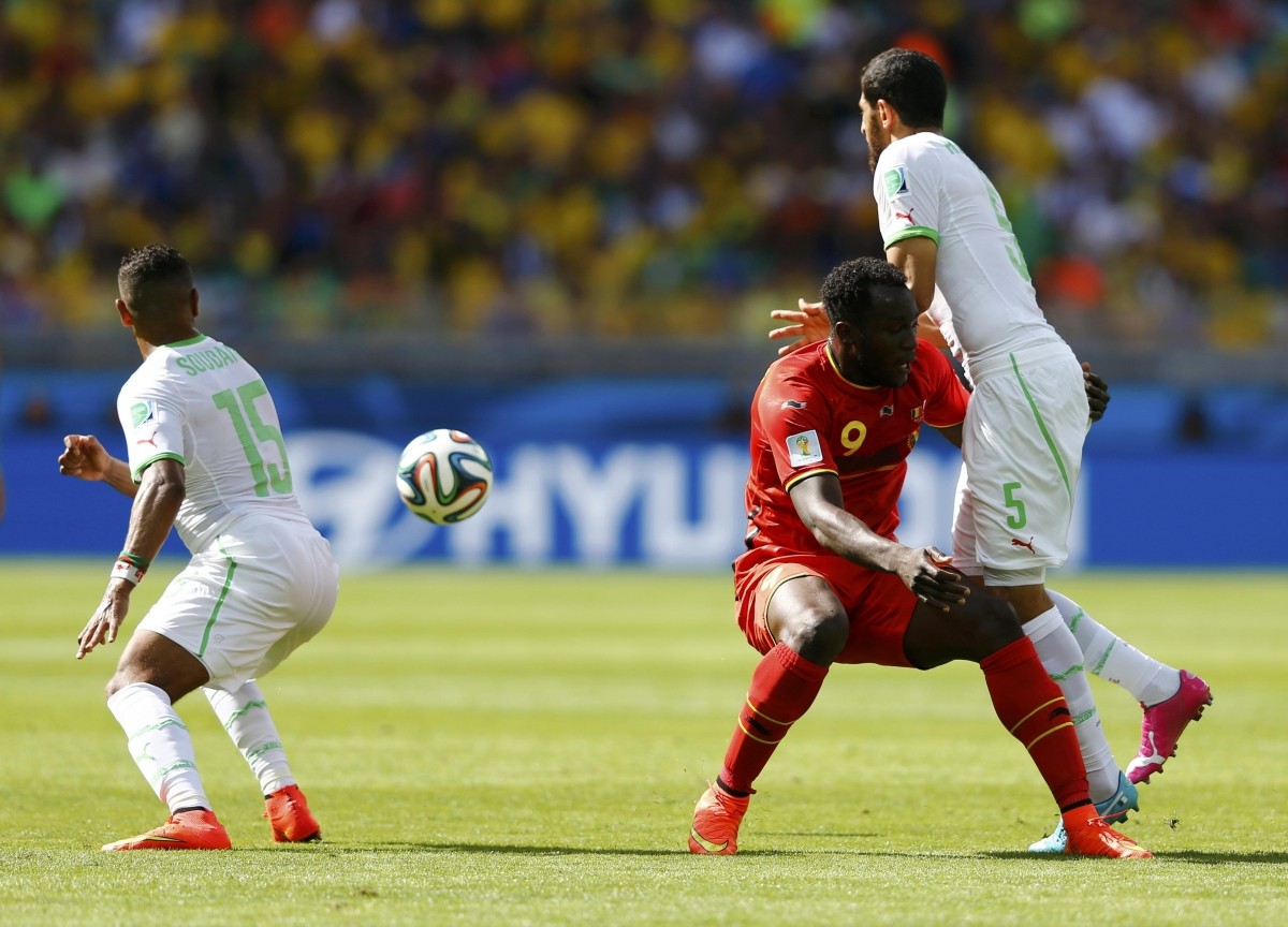 Belgium's Lukaku fights for the ball with Algeria's Bentaleb, Taider and Bougherra during their 2014 World Cup Group H soccer match at the Mineirao stadium in Belo Horizonte Belgium v Algeria