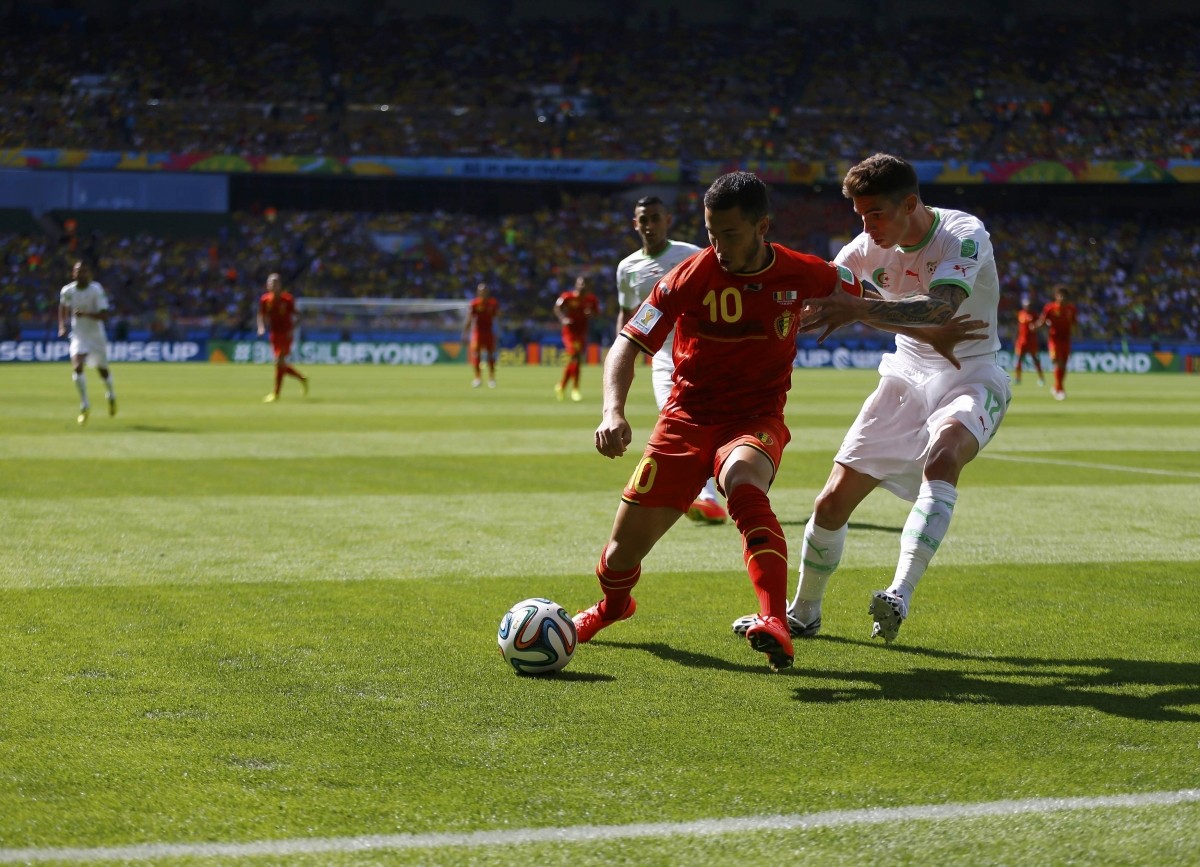 Belgium's Eden Hazard fights for the ball with Algeria's Carl Medjani during their 2014 World Cup Group H soccer match at the Mineirao stadium Belgium v Algeria