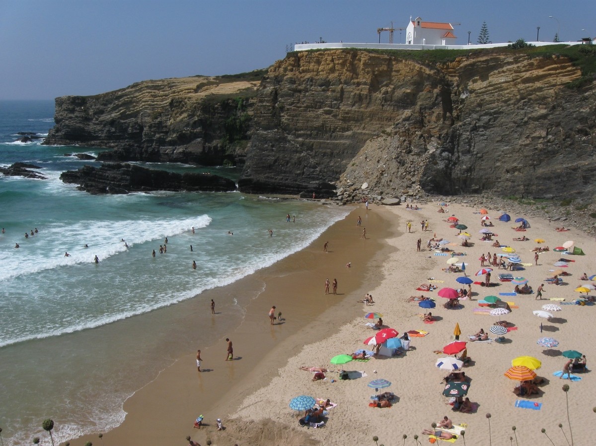Visitors enjoy a day at the beach on July 29, 2008 at Zambujeira do Mar, Portugal. Portugal is becoming an increasingly popular tourist destination. Portugal