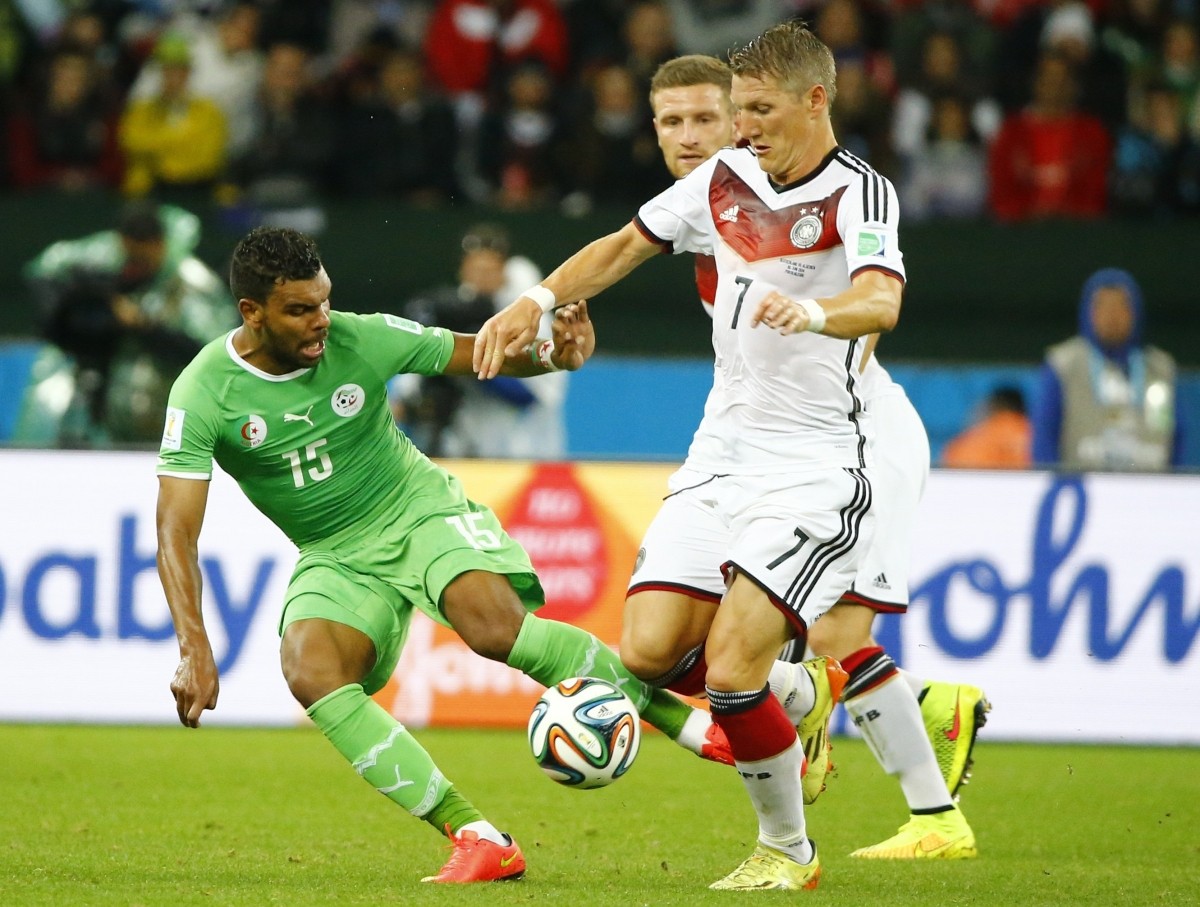 Algeria's Soudani fights for the ball with Germany's Schweinsteiger during their 2014 World Cup round of 16 game at the Beira Rio stadium in Porto Alegre Germany vs Algeria