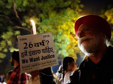 Protesters hold a candle light vigil against what they say was the government’s failure to punish the guilty in the1984 anti-Sikh riots.