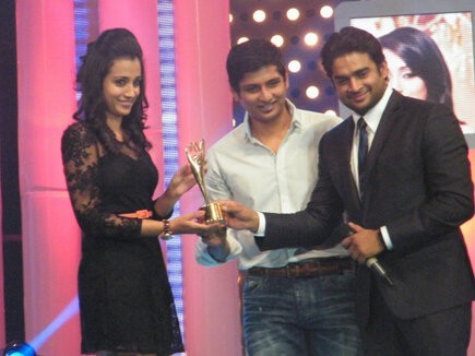 Actress Trisha receiving award from actors Madhavan and Jiiva