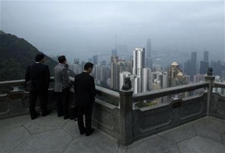 Businessmen at the Peak look at high-rise residential and commercial towers in Hongkong. Businessmen
