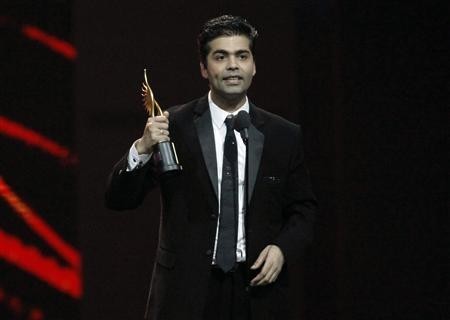 Karan Johar accepts his award for best director for his work in ''My Name is Khan'' during the International Indian Film Academy (IIFA) awards show in Toronto