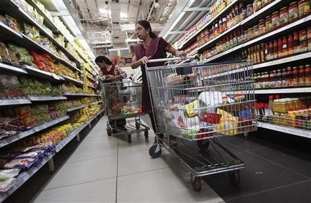 Women shop for instant noodles at a retail supermarket in Mumbai March 16, 2012.