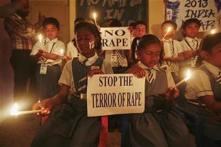 Students hold candles as they pray during a candlelight vigil for a gang rape victim, who was assaulted in New Delhi, in Ahmedabad December 31, 2012.