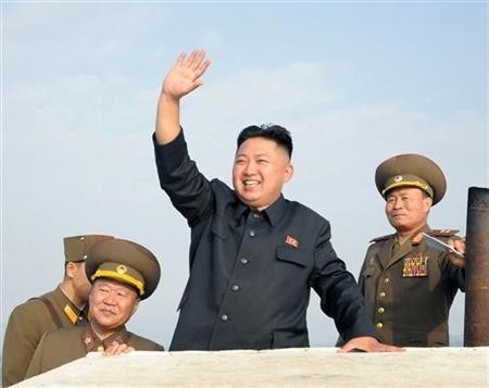 North Korean leader Kim Jong-Un (C) waves as he visits military units