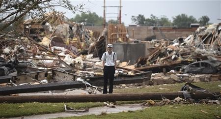 A man stands among the wreckage after a tornado struck Moore, Oklahoma, May 20, 2013. REUTERS/Gene Blevins A man stands among the wreckage after a tornado struck Moore, Oklahoma, May 20, 2013. REUTERS/Gene Blevins