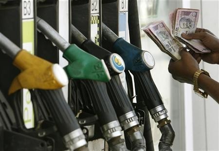 A worker counts Indian currency at a petrol pump in Siliguri February 5, 2008. Petrol pump
