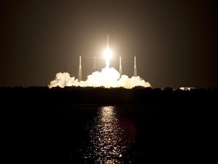 Space Launch Complex 40 is illuminated by a Falcon 9 rocket as it lifts off at 8:35 p.m. EDT carrying a Dragon capsule to orbit on Cape Canaveral Air Force Station in Florida, October 7, 2012. Space X