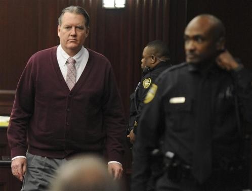 Michael Dunn returns to the courtroom during jury deliberations in his murder trial over the killing of Jordan Davis, in Jacksonville, Florida February 13, 2014.