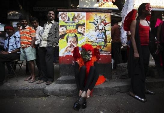A participant wears his shoes on a sidewalk during Queer Azaadi (freedom) parade, an event promoting gay, lesbian, bisexual and transgender rights in Mumbai January 28, 2012.