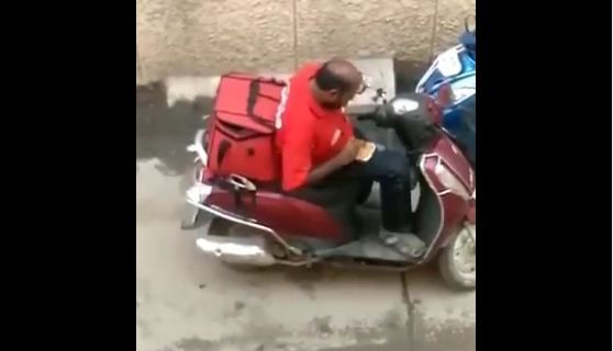 Zomato delivery man eating ordered food Zomato delivery man eating ordered food