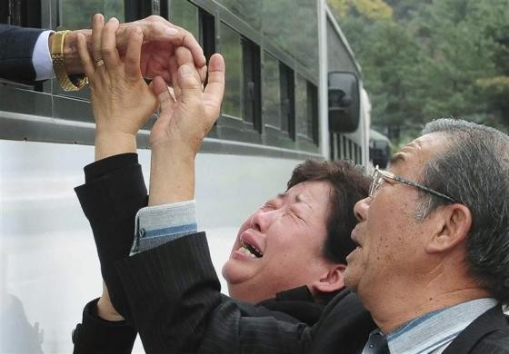 A North Korean man (L) waves from a bus as his South Korean relatives weep after a luncheon meeting during inter-Korean temporary family reunions at Mount Kumgang resort October 31, 2010. A North Korean man (L) waves from a bus as his South Korean relatives weep after a luncheon meeting during inter-Korean temporary family reunions at Mount Kumgang resort October 31, 2010.