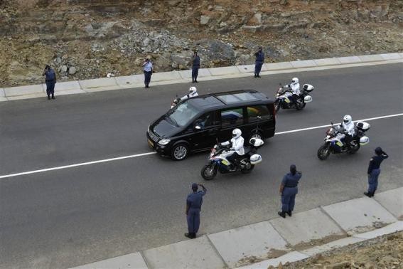 The funeral cortege carrying the coffin of former South African President Nelson Mandela drives through Mandela's homeland just outside the village of Qunu December 14, 2013 The funeral cortege carrying the coffin of former South African President Nelson Mandela drives through Mandela's homeland just outside the village of Qunu December 14, 2013