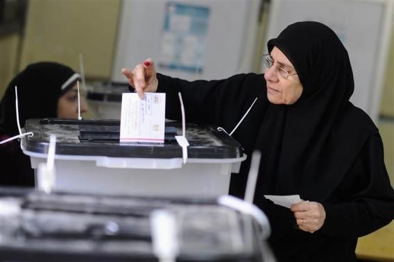 A woman casts her vote at a polling centre during a referendum on Egypt's new constitution in Cairo January 14, 2014.