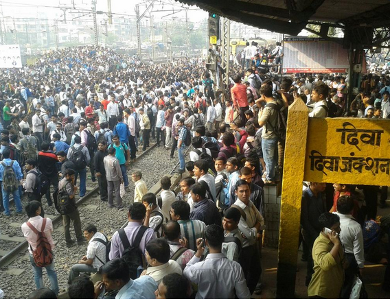 Commuters at Diva station,where angry protesters pelted stones and burned vehicles over delayed train.