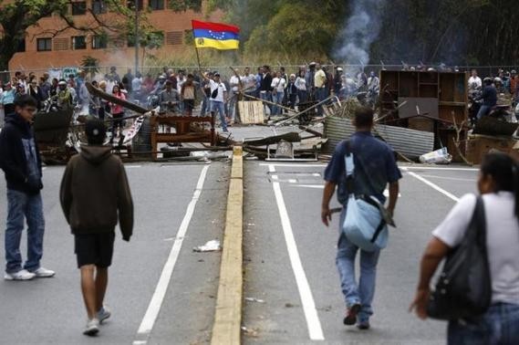 Supporters of opposition leader Leopoldo Lopez stand at a barricade during a protest against Nicolas Maduro's government in a middle-class neighbourhood in Caracas February 20, 2014. (Reuters)