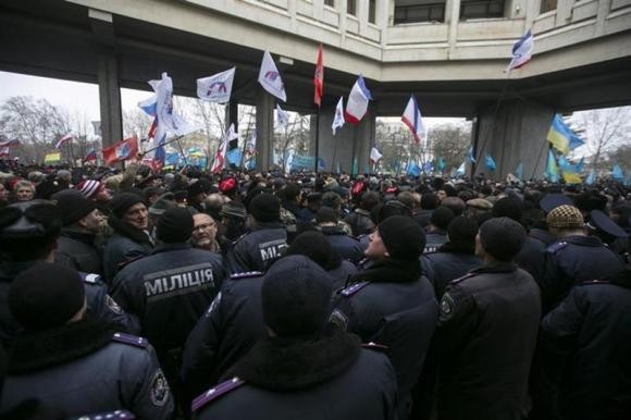 Ukrainian police separate ethnic Russians and Crimean Tatars. Here are five reasons why tensions could lead to a war between Ukraine and Russia. (Reuters)